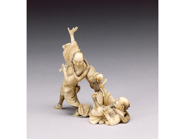 An animated stained ivory okimono,