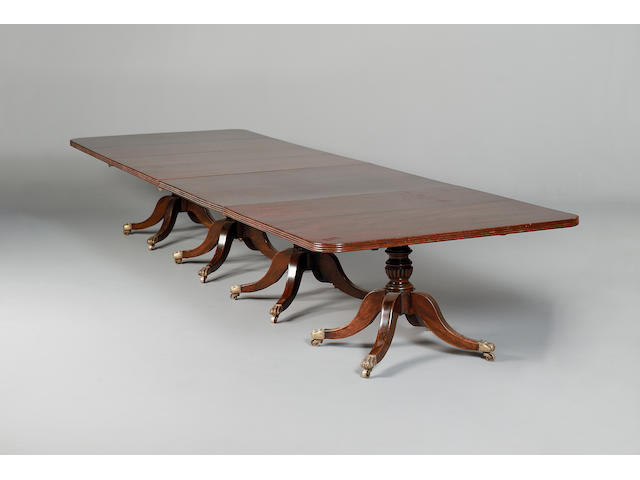 A George III and later mahogany four-pillar dining table