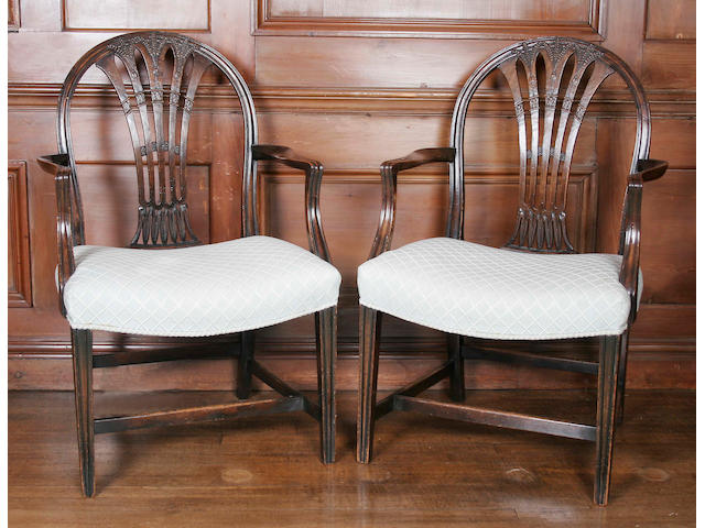 A pair of George III style carved mahogany elbow chairs,