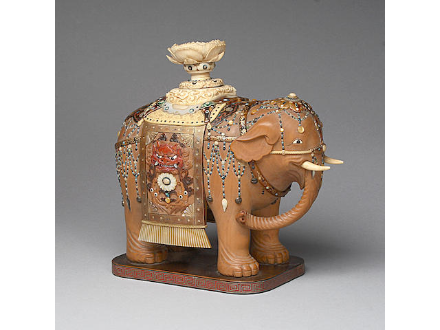 A Japanese carved boxwood, ivory and shibyama model of an elephant,