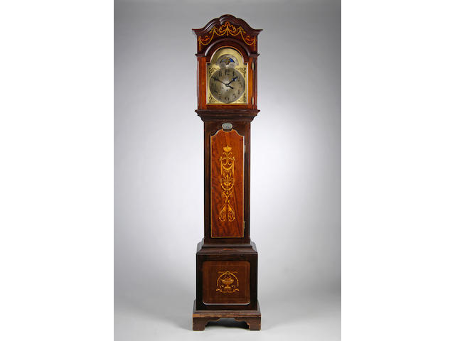 An Edwardian mahogany and inlaid quarter chiming longcase clock