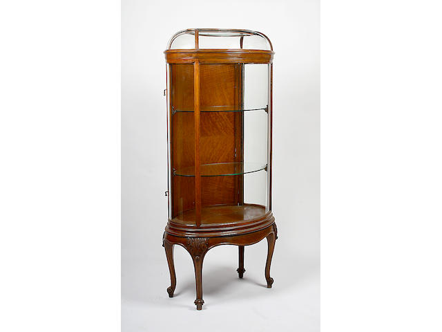 A walnut oval display cabinet,