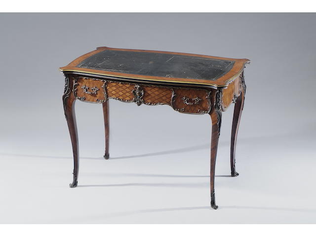 A late 19th Century Louis XV style tulip and rosewood veneered parquetry serpentine writing table Fitted with a frieze drawer to the front with dummy opposite, on cabriole legs, 102 x 64cm.