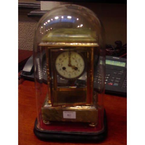 A late 19th Century French green onyx and champleve enamel four glass mantel clock