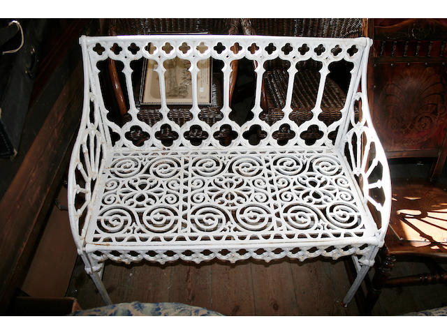 A white painted cast and pierced iron garden seat