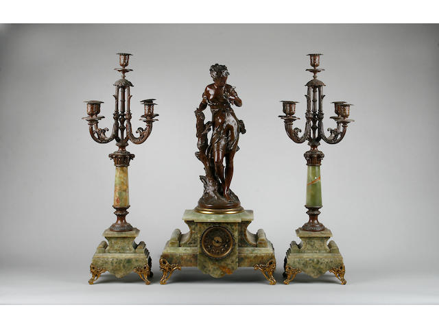 A French figural spelter and onyx clock garniture,