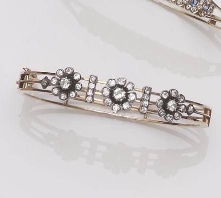 A late Victorian diamond set hinged bangle, circa 1890