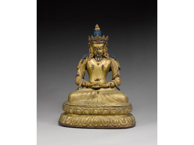 A Tibetan or Himalayan gilt-metal figure of a Deity;