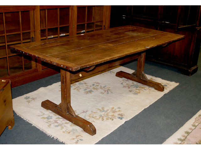 A 17th century style oak trestle dining table