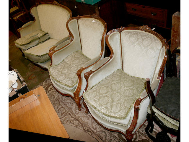 A 20th century carved hardwood framed three piece salon suite