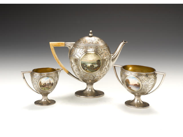 A three-piece Victorian parcel-gilt and enamel mounted pictorial tea set, by Frederick Elkington, Birmingham 1887,  (3)