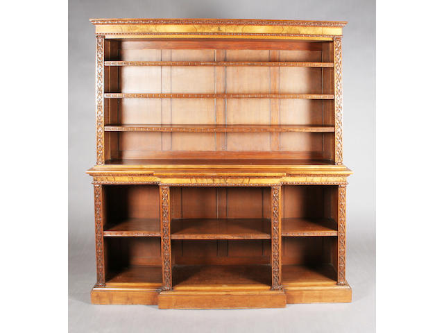 A Victorian figured and foliate carved walnut open bookcase