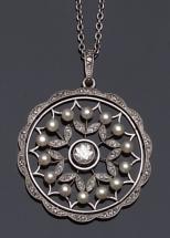 An Edwardian diamond and pearl circular pendant