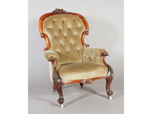 A mid-Victorian carved mahogany frame upholstered gentleman's armchair