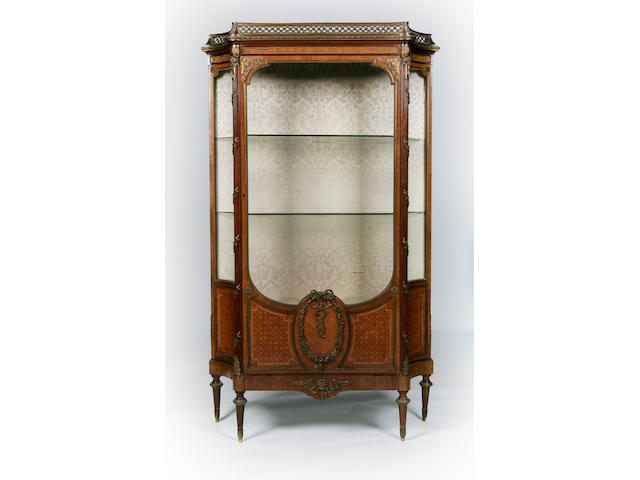 An early 20th century walnut and gilt metal mounted vitrine