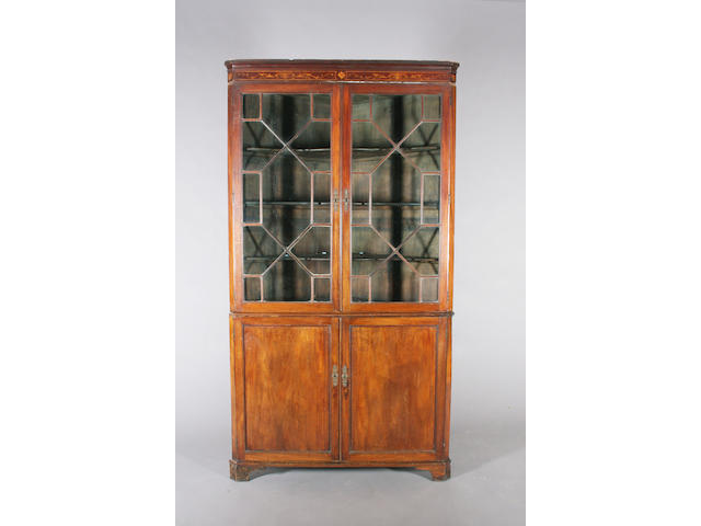 A large George III mahogany floorstanding corner cupboard