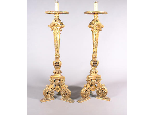 An elaborate pair of late 19th century Baroque design carved giltwood torcheres
