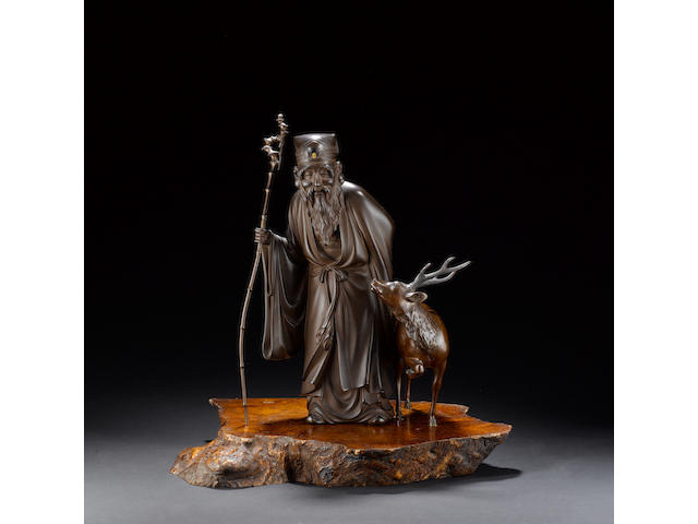 An elegant bronze okimono of Jurojin and his stag;