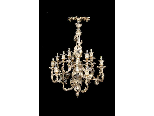 A pair of Rococo style gilt metal two tier twelve light chandeliers