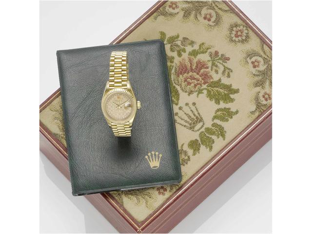 Rolex. A fine lady's 18ct gold diamond set automatic centre seconds calendar bracelet watch with fitted boxDatejust, Ref:69178, Sold May 18th 1984