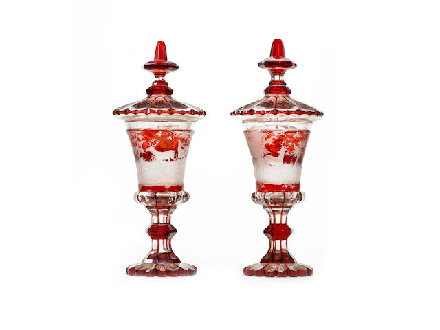 A pair of late 19th century Bohemian etched glass vases and covers