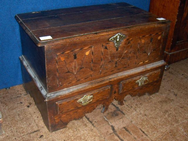 An 18th century oak and inlaid coffer bach