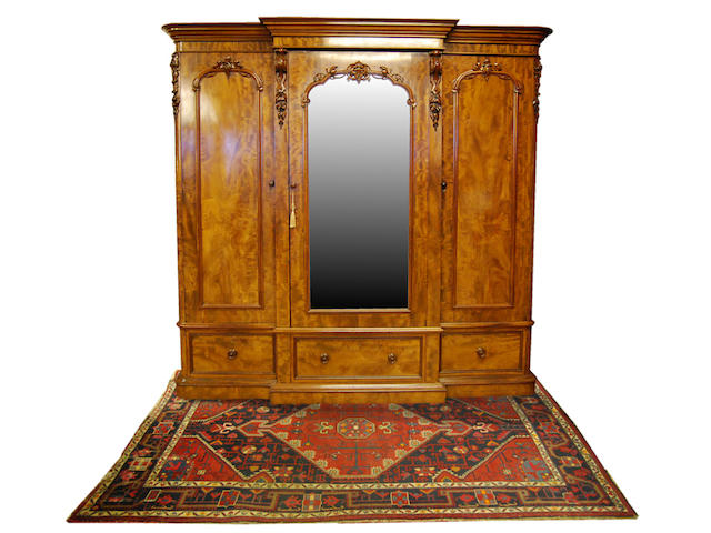 A mid-Victorian figured mahogany breakfront triple wardrobe