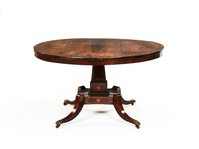 A Regency rosewood and brass inlaid breakfast table