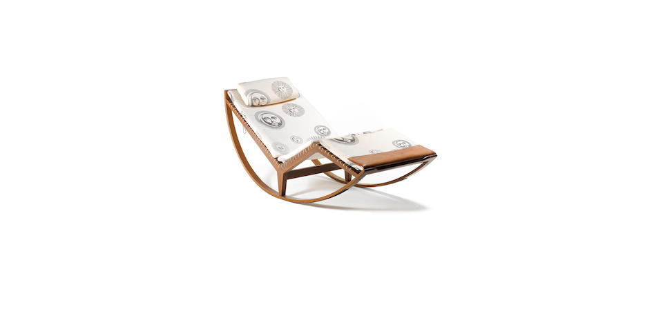 Franco Albini for Poggi, a 'PS16' rocking chair, designed 1956 the walnut frame with canvas seating, together with four various Fornasetti 'Suns Ivory' fabric and leather cushion covers
