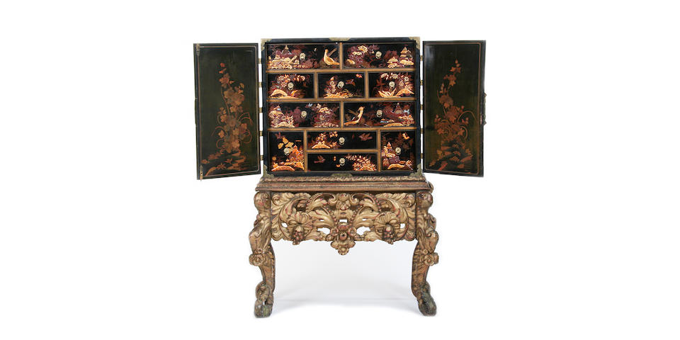A black and gilt japanned cabinet on giltwood stand
