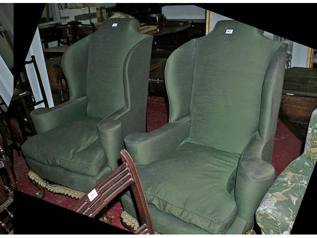 A pair of 20th Century shaped wing back armchairs,