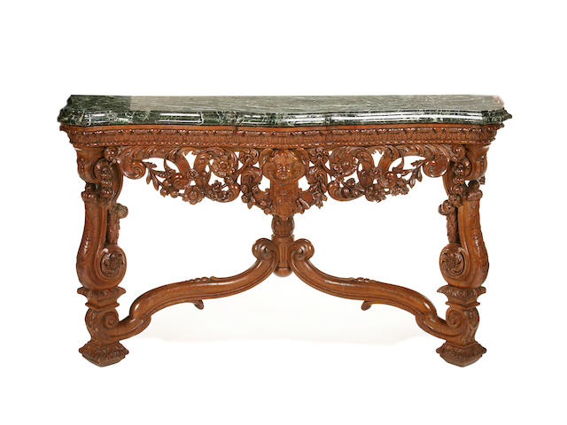 A pair of first half 20th century carved fruitwood serpentine console tables in the Baroque style