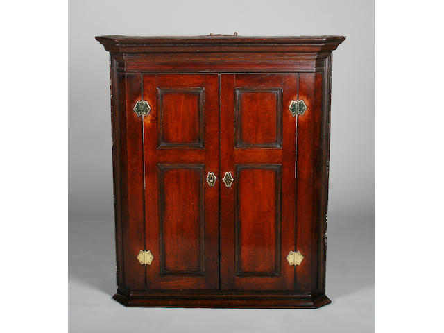 A George III oak hanging corner cupboard