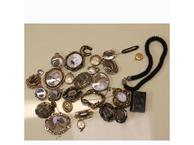 A collection of memorial brooches and lockets,