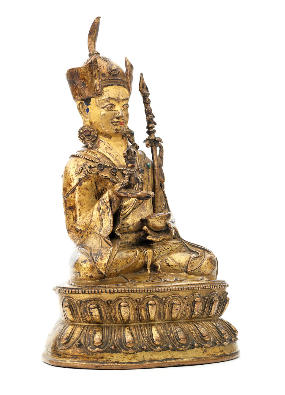 A gilt-copper figure of Padmasambhava Tibet, circa 15th century