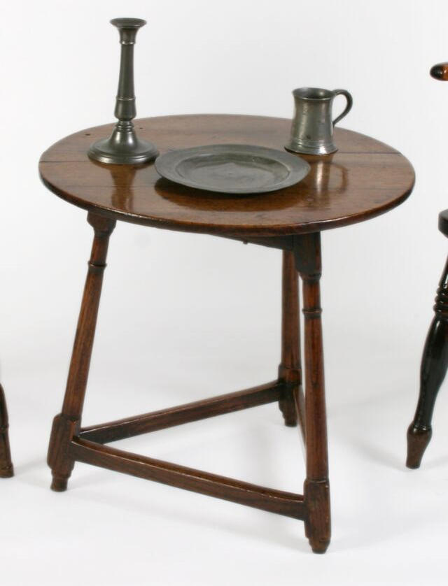 A mid 19th Century oak cricket table with circular top,