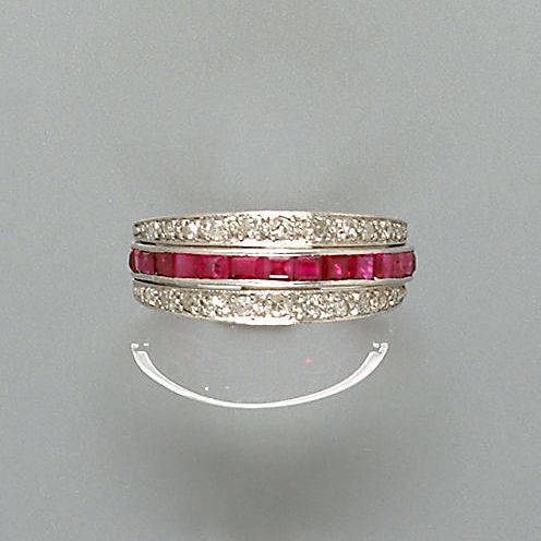 A diamond, sapphire and ruby swivel ring