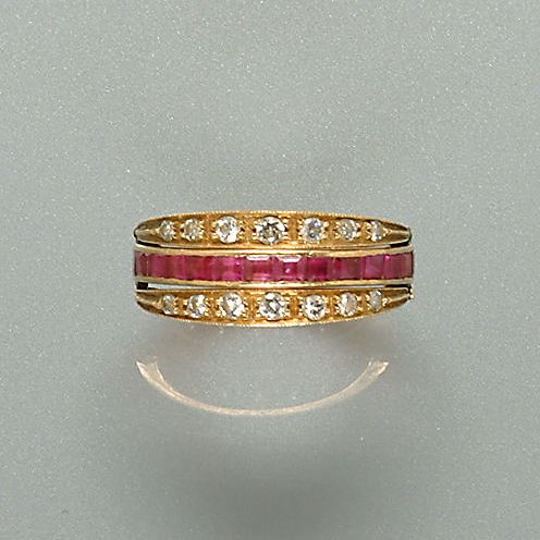 A diamond emerald and ruby swivel eternity ring,