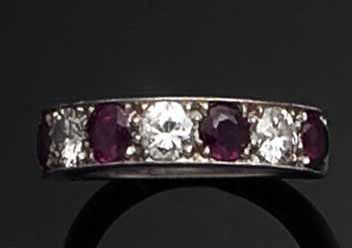 A ruby and diamond half hoop eternity ring