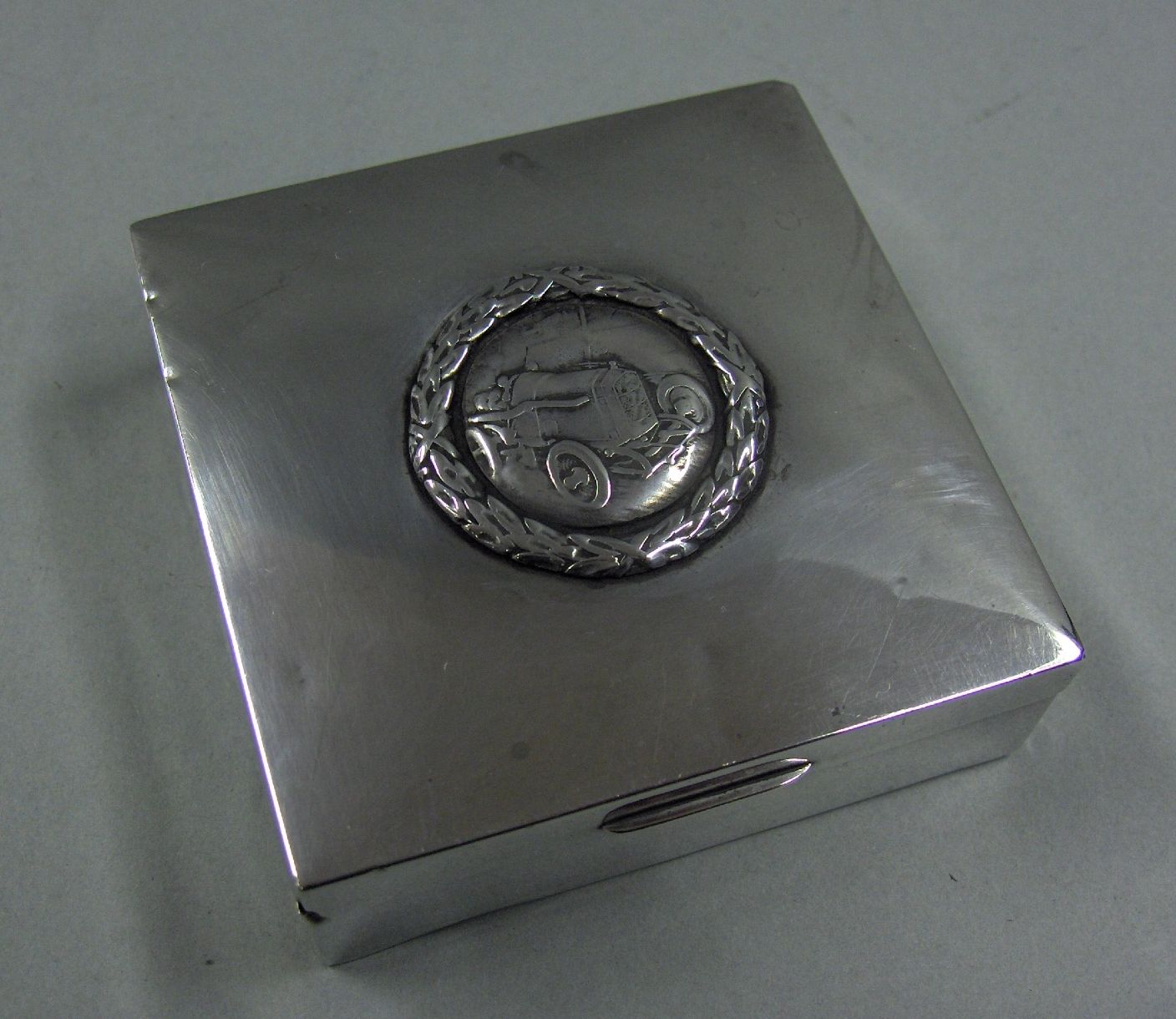 Bonhams Cars : A silver motor-racing cigarette box, British,