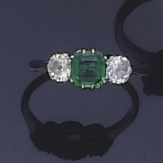 An emerald and diamond ring