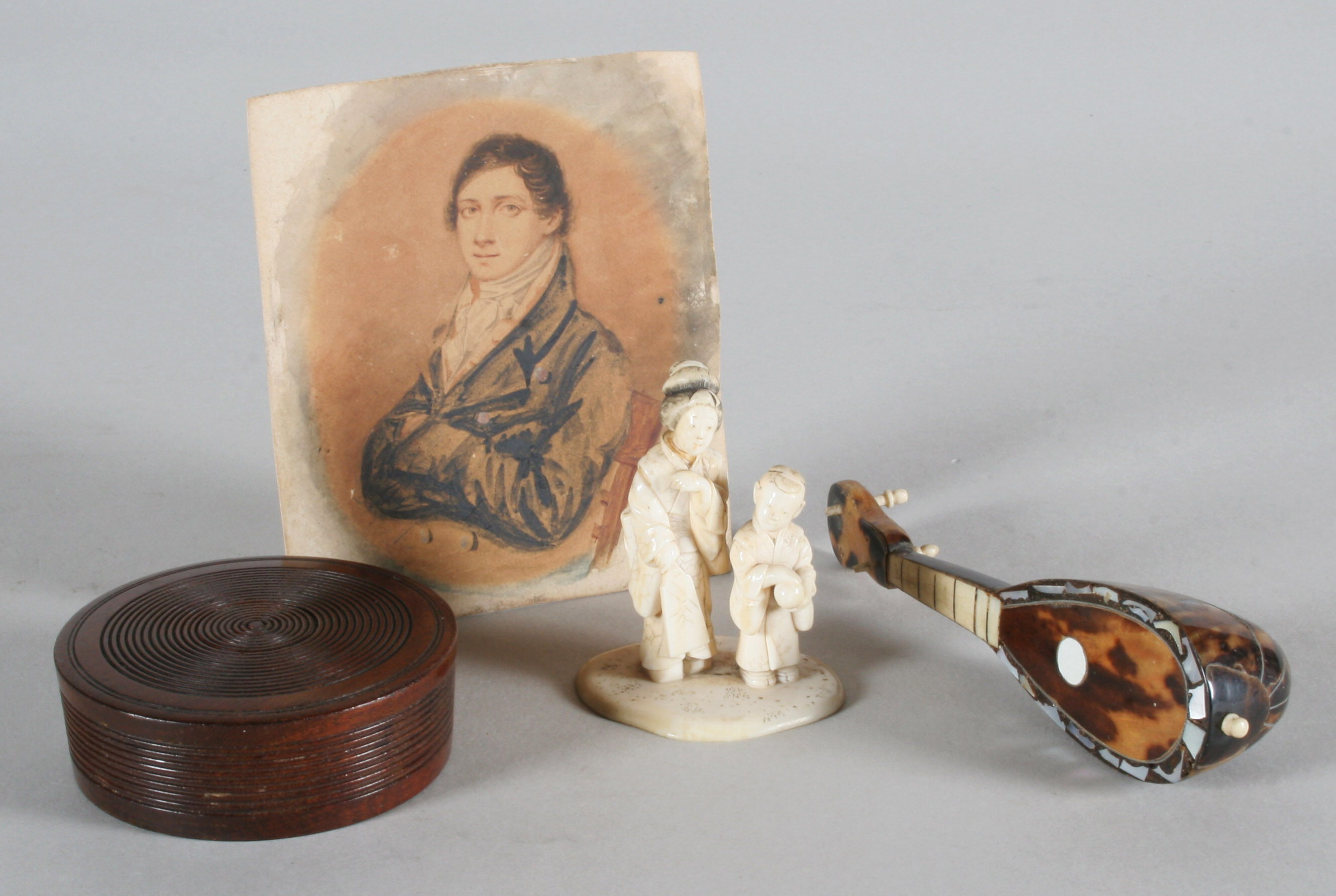 A small Japanese carved and stained ivory group of two figures ...