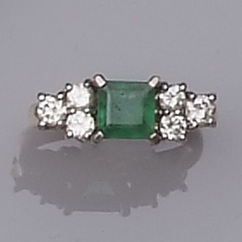 An emerald and diamond ring