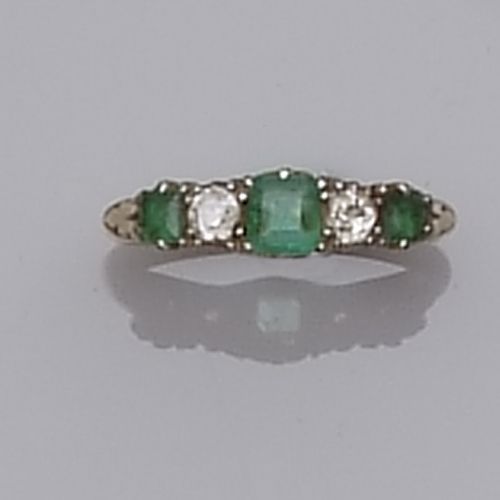 An emerald and diamond five stone ring