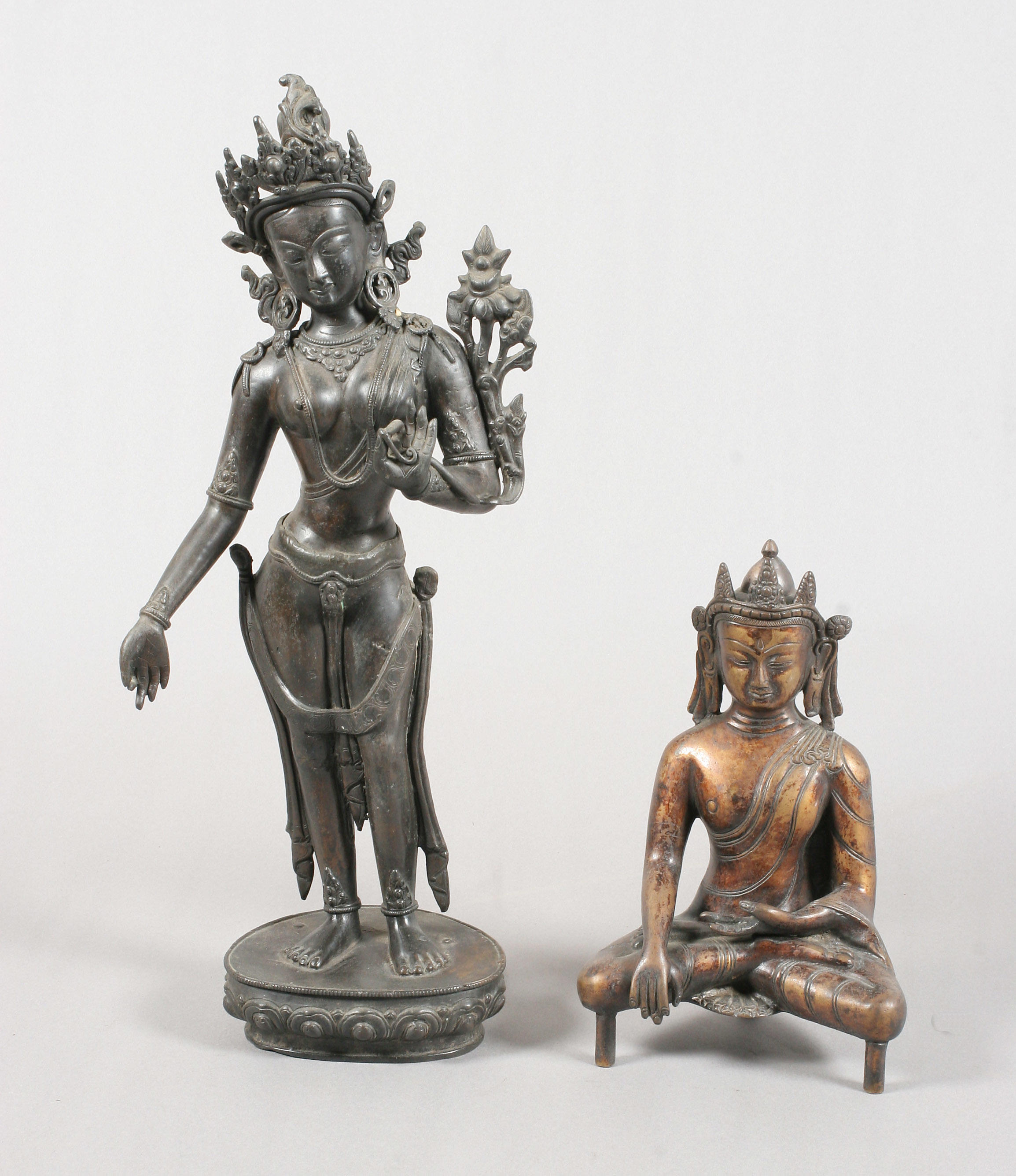 A Chinese brown patinated bronze figure of a deity