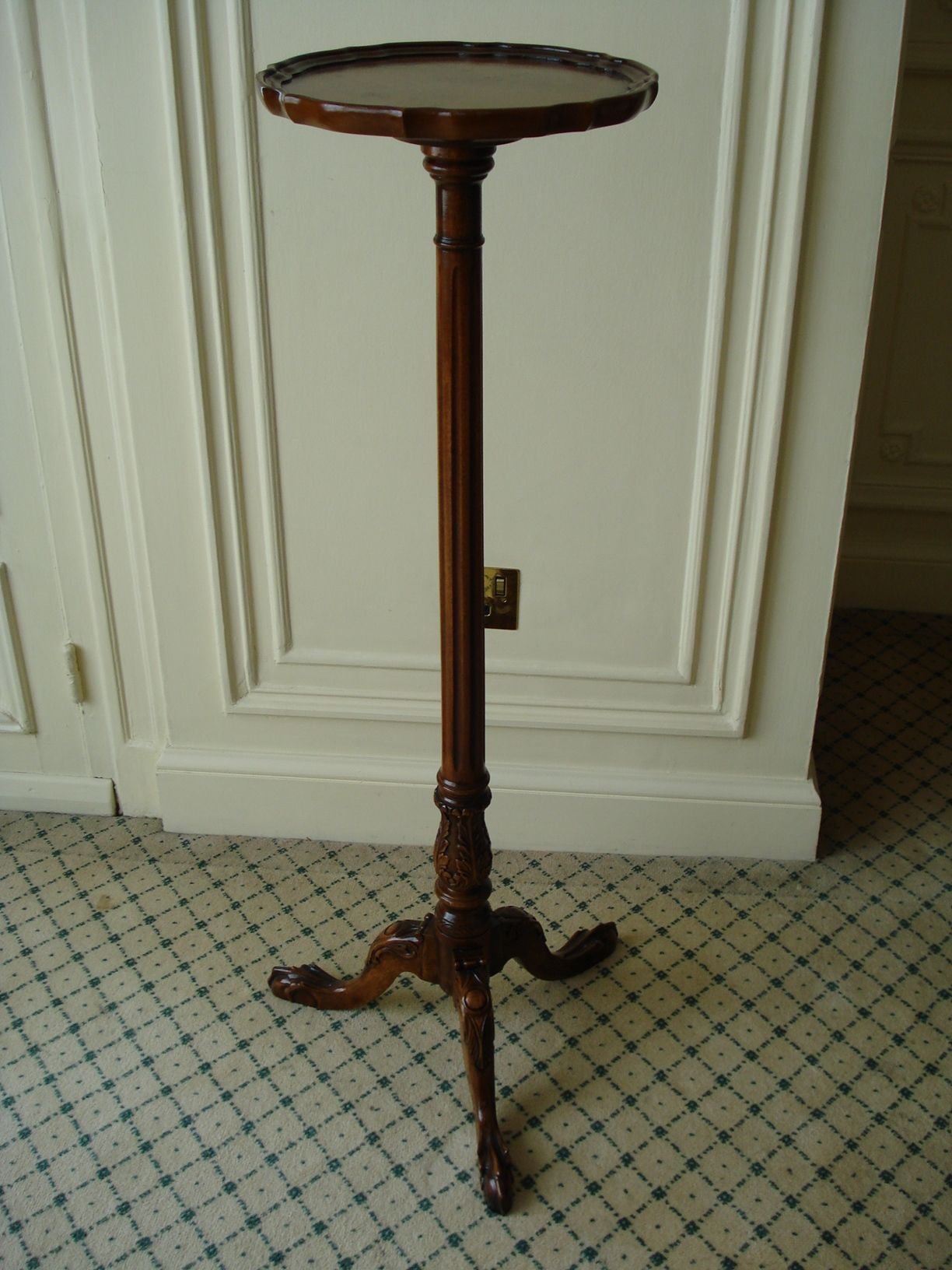 A walnut torchère stand