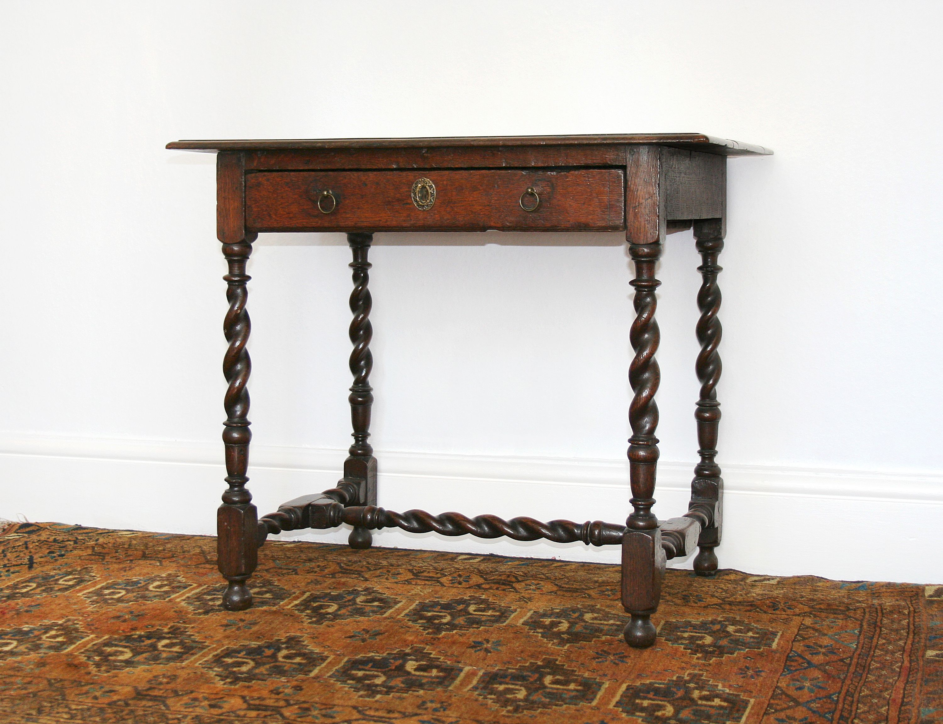 An oak single-drawer side table