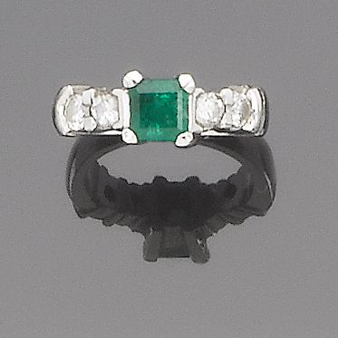 An emerald and diamond ring