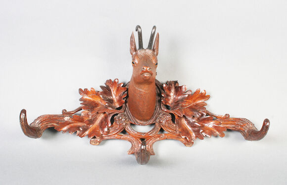 Bonhams : A Black Forest carved linden wood wall mounting coat rack