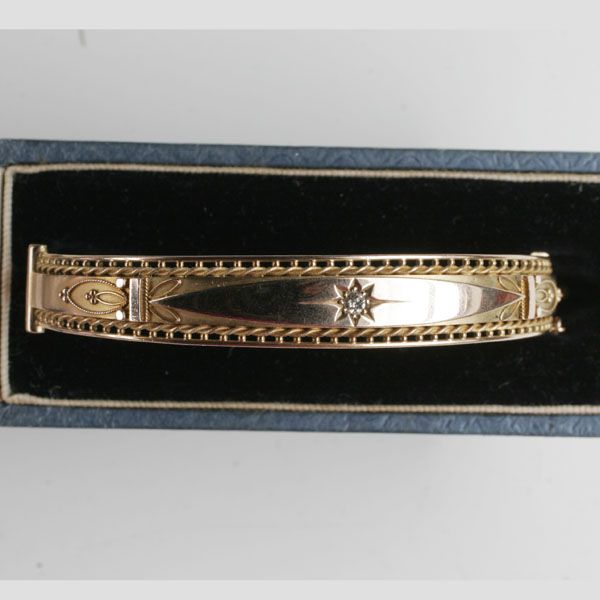 A 9ct gold diamond set hinged bangle
